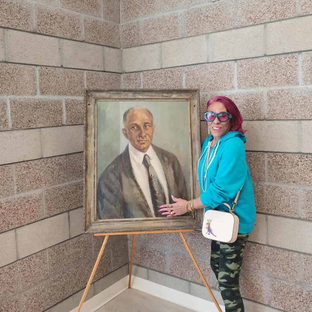 Vice President Pamela Stovall Hill with a painting of her father Dr. Leonard Stovall
